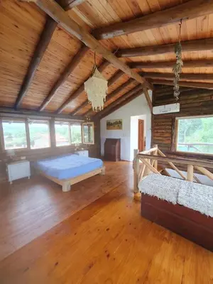 a large room with a bed and a wooden ceiling at La Traviata in Mina Clavero