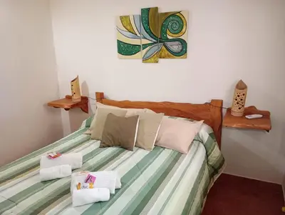a bedroom with a bed with towels on it at Viejo Camino Real in Santa Rosa de Calamuchita
