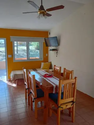 a dining room table with chairs and a ceiling fan at Viejo Camino Real in Santa Rosa de Calamuchita