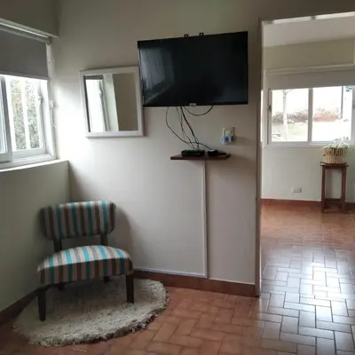 a living room with a flat screen tv on the wall at Viejo Camino Real in Santa Rosa de Calamuchita