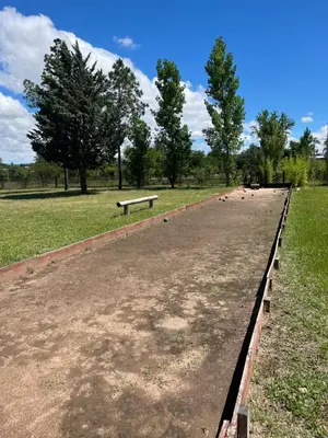 a long path in a park with a bench at Complejo de cabañas en Nono in Nono