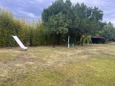 a park with two play equipment in the grass at Complejo de cabañas en Nono in Nono