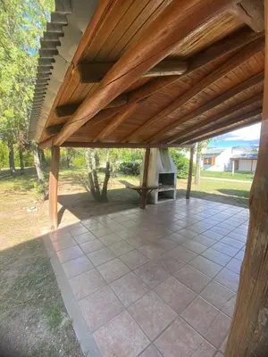 an outdoor patio with a wooden pergola at Complejo de cabañas en Nono in Nono