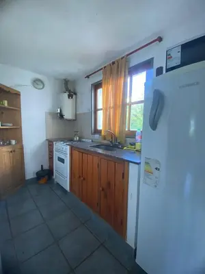 a kitchen with a white refrigerator and a window at Complejo de cabañas en Nono in Nono