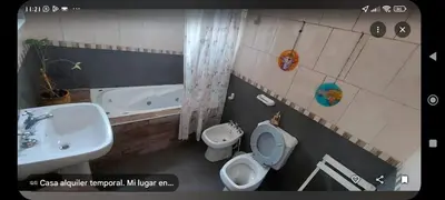 a bathroom with a toilet and a sink and a tub at Tu lugar in San Antonio de Arredondo