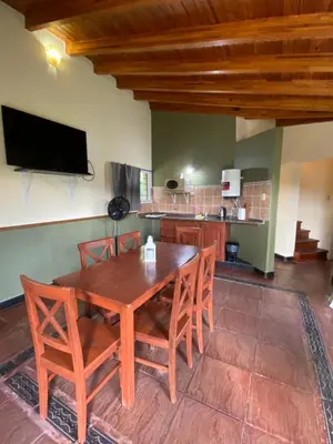 a dining room with a wooden table and chairs at San Roque in San Roque