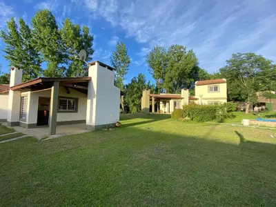 a house with a lawn in front of it at San Roque in San Roque