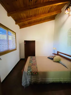 a bedroom with a bed in a room with a wooden ceiling at San Roque in San Roque