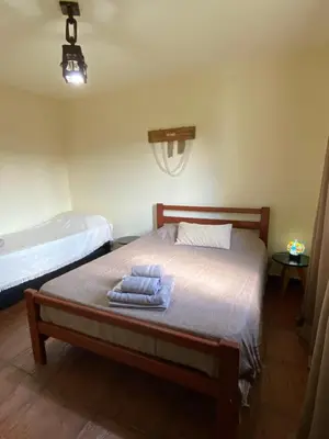 a bedroom with a bed with towels on it at San Roque in San Roque