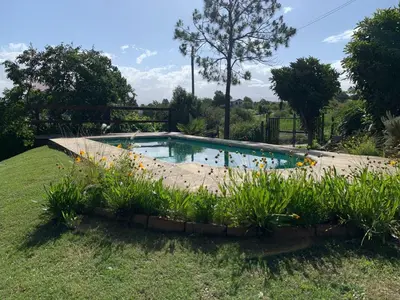 a swimming pool in the middle of a yard at Estacion Potrero cabaña grande in Potrero de Garay