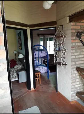 a view of a room with a bedroom and a bed at Estacion Potrero cabaña grande in Potrero de Garay