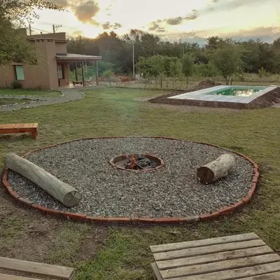 a fire pit in the middle of a yard at Alebrijescalamuchita in Villa Ciudad Parque