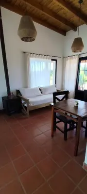 a living room with a bed and a table at Alebrijescalamuchita in Villa Ciudad Parque