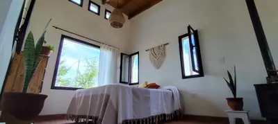 a room with a table with a white sheet on it at Alebrijescalamuchita in Villa Ciudad Parque