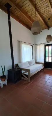 a bedroom with a bed in a room with windows at Alebrijescalamuchita in Villa Ciudad Parque