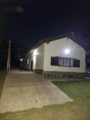 a building with a light on the side of it at night at Rancho La Paz in Los Reartes