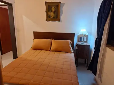 a bedroom with a bed and a picture on the wall at Rancho La Paz in Los Reartes
