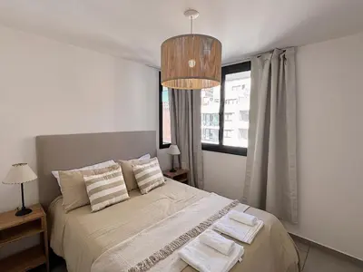 a bedroom with a bed with two towels on it at Apartamento Obispo Trejo, Nueva Cordoba in Cordoba