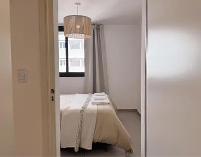 a bedroom with a bed with towels on it at Apartamento Obispo Trejo, Nueva Cordoba in Cordoba