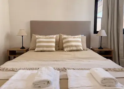 a bedroom with a large bed with towels on it at Apartamento Obispo Trejo, Nueva Cordoba in Cordoba