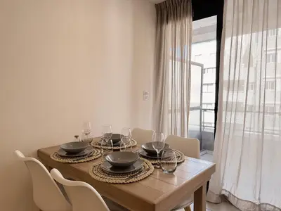 a dining room table with wine glasses on it at Apartamento Obispo Trejo, Nueva Cordoba in Cordoba