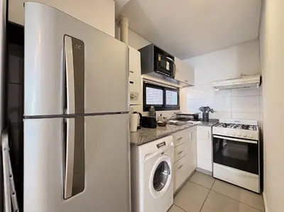 a kitchen with a refrigerator and a washer and dryer at Apartamento Obispo Trejo, Nueva Cordoba in Cordoba