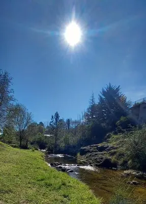 a river with the sun shining in the sky at 