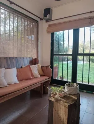 a living room with a couch and large windows at 