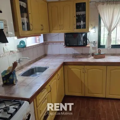 a kitchen with yellow cabinets and a sink at 