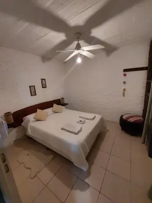 a bedroom with a bed with a ceiling fan at Pasión Serrana in Las Calles