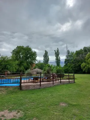 a fence with a pool and tables in a field at Pasión Serrana in Las Calles