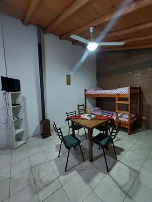 a room with a table and chairs and a bed at Pasión Serrana in Las Calles