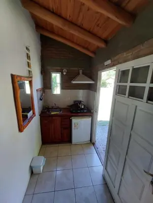 a kitchen with a white refrigerator and a door at Pasión Serrana in Las Calles