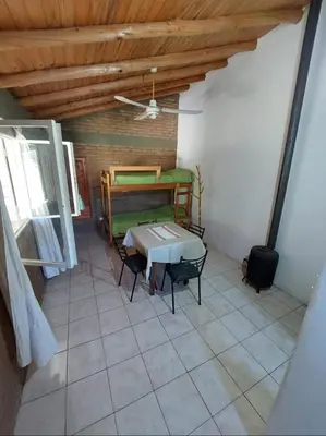 a room with a bed and a table and chairs at Pasión Serrana in Las Calles