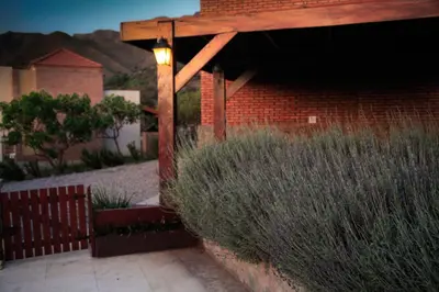 a garden with a brick building with a light on it at INCA HUASI - Cabañas de Altura in El Rincón
