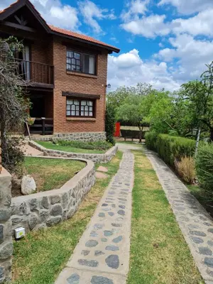 a walkway in front of a house at INCA HUASI - Cabañas de Altura in El Rincón