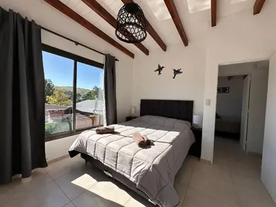 a bedroom with a bed and a large window at Complejo Montana Departamento 3 in Potrero de Garay