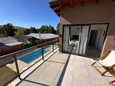 a balcony of a house with a swimming pool at Complejo Montana Departamento 3 in Potrero de Garay