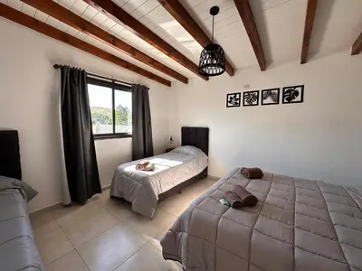 a bedroom with a bed and a large window at Complejo Montana Departamento 3 in Potrero de Garay