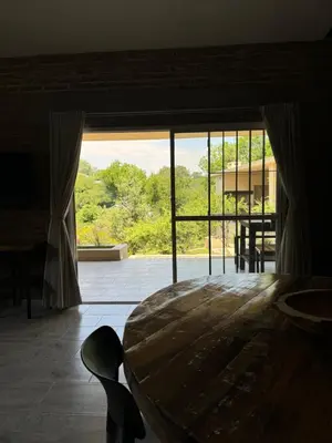 a large room with a table and a large window at Cabañas Cuesta in Cordoba
