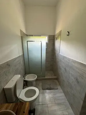 a bathroom with a toilet and a sink and a shower at Cabañas Cuesta in Cordoba
