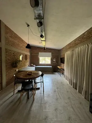 a living room with a table and a bed at Cabañas Cuesta in Cordoba