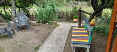 a group of chairs sitting in a garden at La Lugarda in Cuesta Blanca