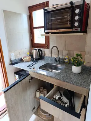 a kitchen with a sink and a microwave at Potrero Loft in Potrero de Garay