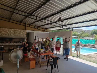 a group of people standing in a room with a pool at Dúplex, Alejandría in Villa Carlos Paz
