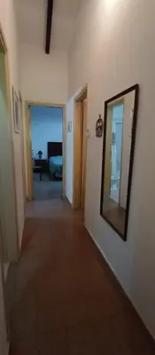 a hallway with a mirror on a wall at Villa Clara in Villa Parque Siquiman