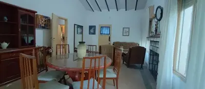a dining room and kitchen with a table and chairs at Villa Clara in Villa Parque Siquiman
