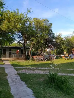 a park with a bench and a picnic table and trees at Valle Hermoso in Mina Clavero