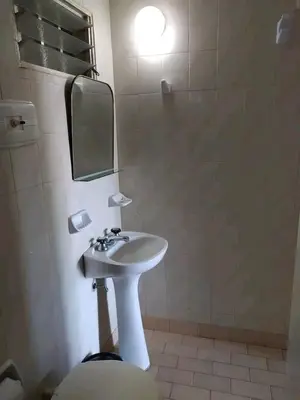 a bathroom with a sink and a mirror and a toilet at Valle Hermoso in Mina Clavero