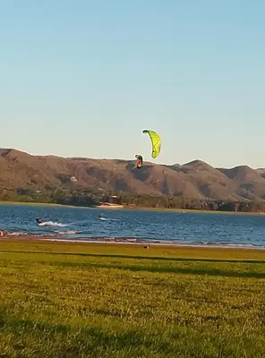 a person flying a kite over a body of water at Casa WIWI in La Estancia